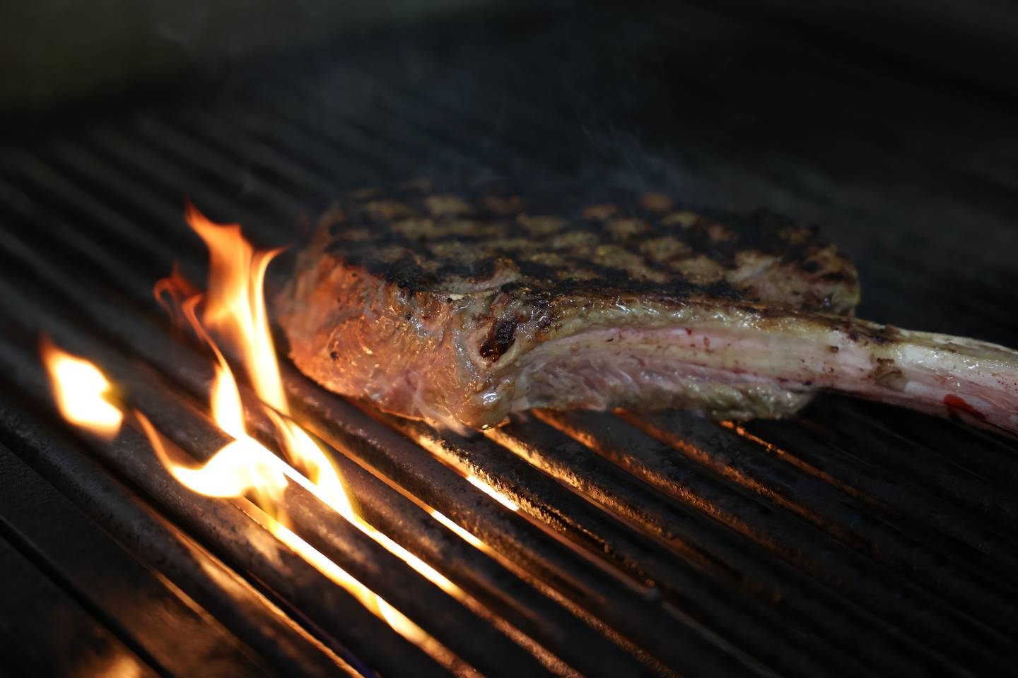 Executive Chef Jeremy Kenyon cooks a tomahawk ribeye at Cut 158 Chophouse.