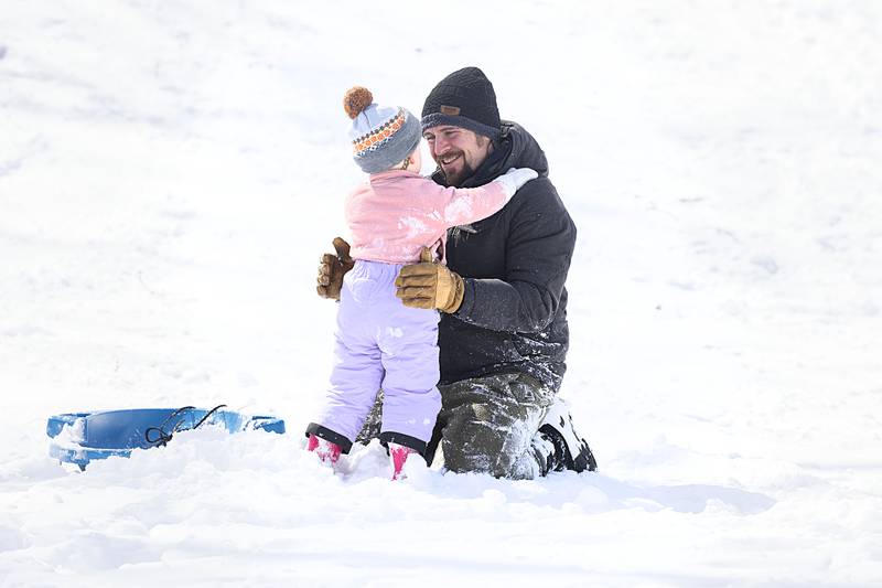 Dad Nick DeLancey comforts Cecily after a wild sled run Monday, March 16, 2026, in Dixon.