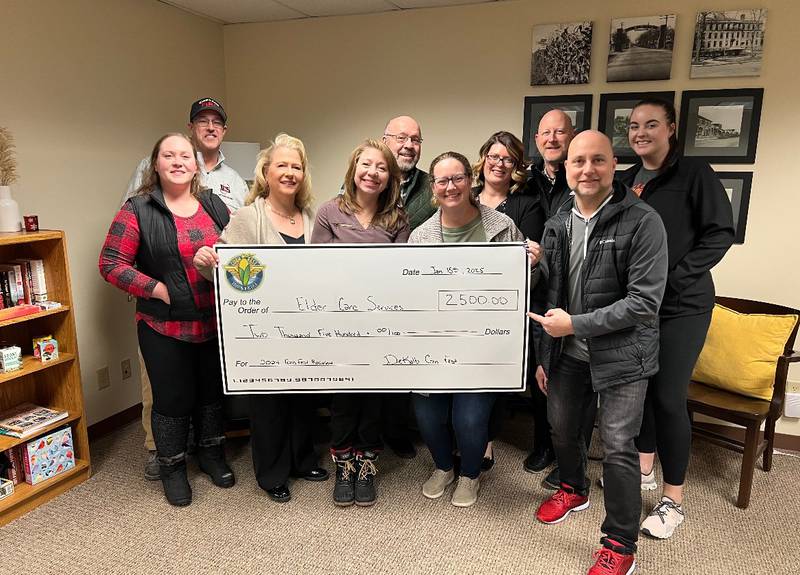 The DeKalb Corn Fest board presents a check to Elder Care Services in DeKalb for $2,500. The nonprofit was chosen as the recipient for the 2024 festival. (From left) Sara Myers, Brian Reynolds, Lisa Angel, Colleen Parks, John Rey, Christi Coulter, Jessica Dewey, Shawn Lowe, Brian Oster, and Kelsey Van Vlerah.