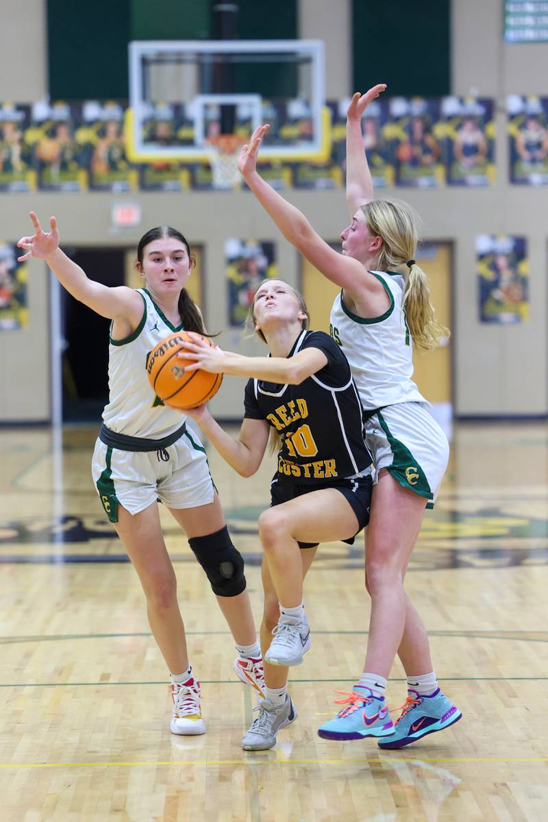 Reed-Custer's Kamryn Wilkey looks to shoot under pressure form Coal City's Becca Hall, left, and Kyla Stark during the Comets' 50-43 victory over Coal City on Monday, Jan. 11, 2026.