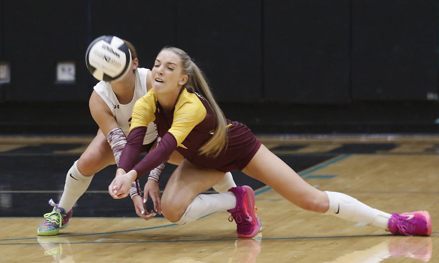 Richmond-Burton's Daniella Hopp (right) almost collides with her teammate, Delanee Cooley, as she bumps the ball forward during a Kishwaukee River Conference volleyball match against Woodstock North on Monday, Sept. 15, 2025, at the Woodstock North High School.