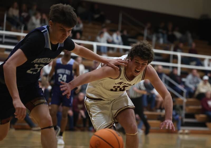Morris’ Cade Luademan fights off Plainfield South’s Joell Tunnat for the loose ball on Wednesday, Jan 29, 2025 in Morris.