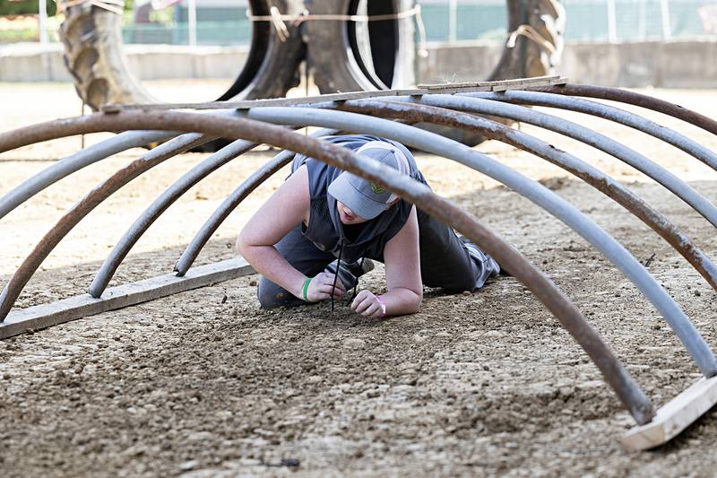 Jackson Geerts, 13, of Milledgeville crawls through an obstacle Saturday, Aug. 10, 2024 in the Ninja Farmer course at the Carroll County Fair.