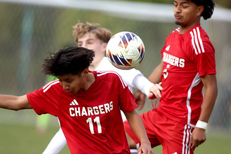 Dundee-Crown’s Ayden Hernandez, left, and Jonathan Varela, right, battle St. Charles East’s Brendan Szerlong, back, in IHSA Class 3A Regional Championship soccer at Dundee-Crown High School in Carpentersville on Saturday, October 25, 2025.