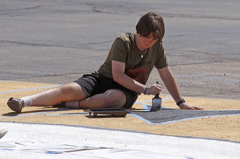 Marian Central Catholic High School senior  Colin Zecchin paints his parking spot on Tuesday, Aug. 13, 2024.