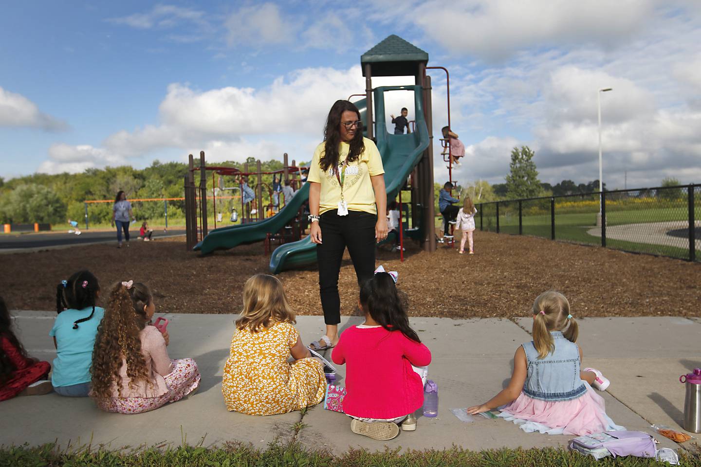 Principal Nikki Kunde talks with students as they eat a snack on the playground Monday morning, August 15, 2022, during the first day of school at District 200’s Prairiewood Elementary School. Many McHenry County area schools return to session this week.