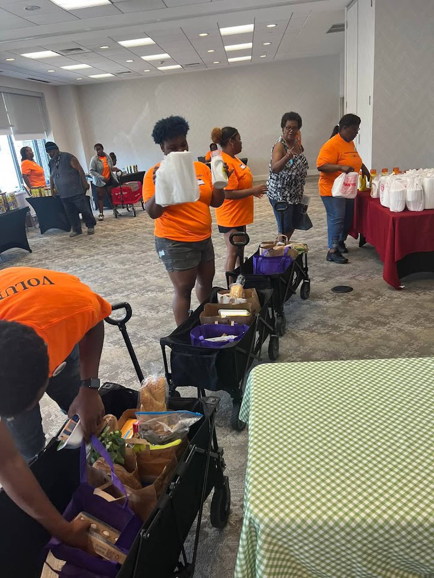 Volunteers work at a pop-up Complimentary Nutrition Station for the community, hosted by the Center for Food Equity in Medicine. The center's founder, Ann Jackson, inspired Joliet social worker Paul Dickerson to found his own nonprofit to help provide healthy food to cancer patients in Will County.