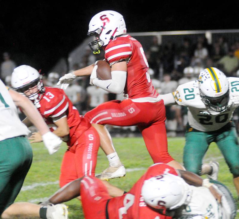 Streator quarterback Sam Lerette hops over other players in their game against Coal City on Friday, Sept. 19, 2025 at Doug Dieken Stadium.