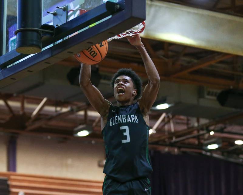 Glenbard West's TJ Williams (3) dunks during their basketball game between Glenbard West at Downers Grove North. Jan 24, 2025 in Downers Grove.