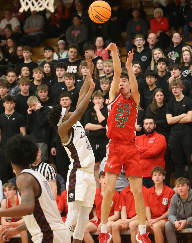 L-P's Nick Olivero shoots a jump shot over Peoria's Nigel Moore during the Class 3A Sectional semifinal game on Wednesday, March 5, 2025 at Washington High School.
