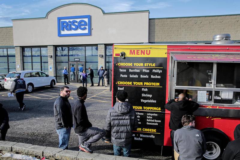 Several customers can be seen waiting in line for food and recreational marijuana Thursday near the Louis Joliet Mall in Joliet.