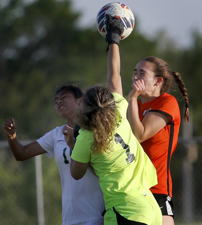 Boylan's Natalya Razo punches the ball away as Crystal Lake Central's Jillian Mueller tries to head the ball over the defense of Boylan’s Mary Therese Harrison during the IHSA Class 2A Burlington Central Girls Soccer Sectional final match Friday, May 26, 2023, at Burlington Central High School.