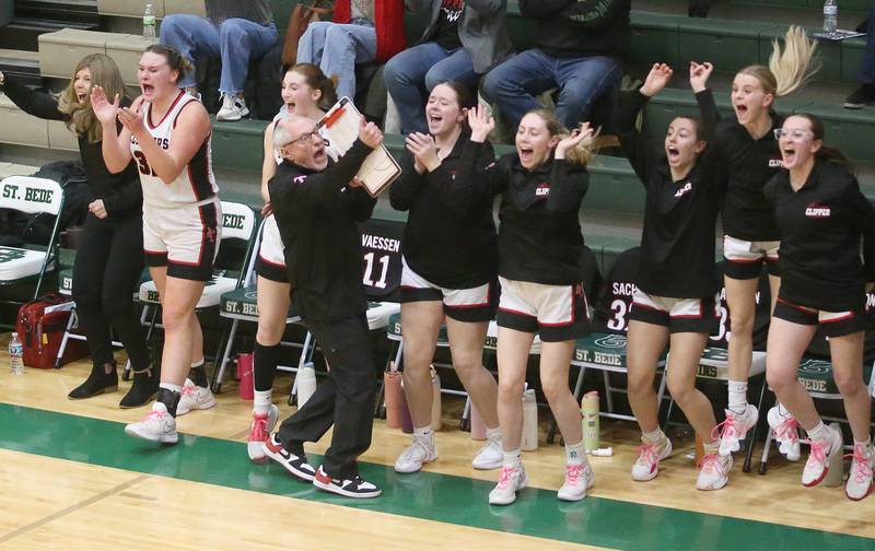 Members of the Amboy/Ohio girls basetball team react after teammate Tyrah Vaessen drilled a three-point basket to end the third quarter against Marquette during the Class 1A Regional championship on Thursday, Feb. 20, 2025 at St. Bede Academy.