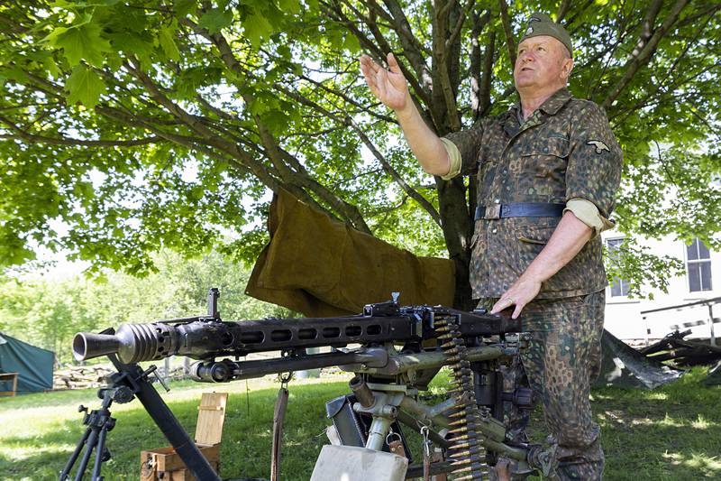 Herb Kaelin of West Brooklyn talks about the devastating 8mm Mauser machine gun dubbed “Hitler’s Buzz Saw” Saturday, May 16, 2026, during the World War II reenactment in Franklin Grove.