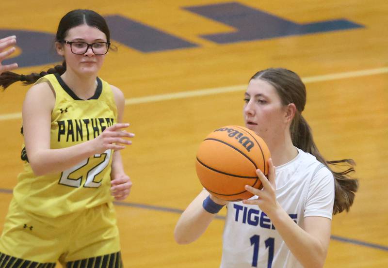 Princeton's Addy Dever, looks to pass the ball off around Putnam County's Addy Leatherman, during the Tiger Girls Basketball Holiday Tournament on Tuesday, Nov. 18, 2025 at Princeton High School.