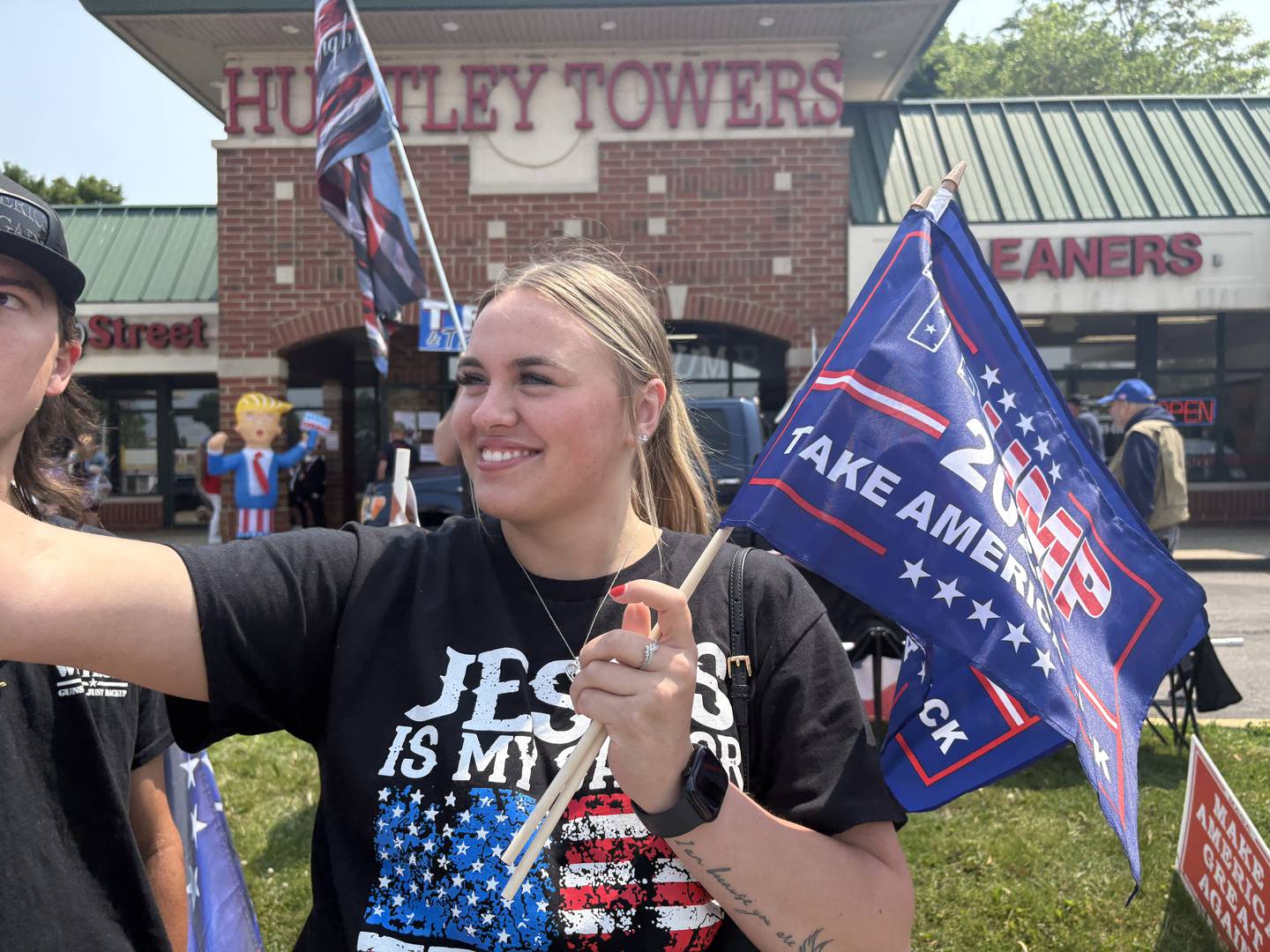 Ireland Mahoney hands out flags at a rally in front of the Trump and Truth Store in Huntley May 31, 2025.