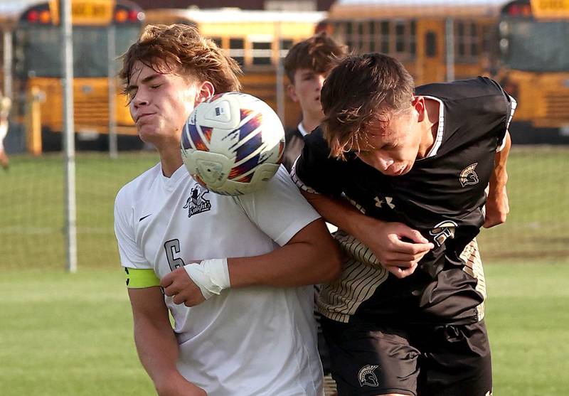 Kaneland's Noah McKittrick (left) and Sycamore's Felix Arends head a ball during their game Wednesday, Sept. 18, 2024, at Sycamore High School.