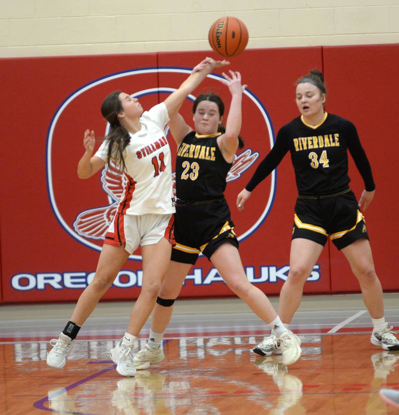 Riverdale's Jillian Murray (23) and Stillman Valley's Joslyn Nanni (11) battle for the basketball as Carrieanne Hungate (34) watches on Tuesday. Feb. 20, 2024 at the 2A Oregon Sectional held at the Blackhawk Center at Oregon High School. The Rams' season ended with a 57-34 loss to the Cardinals.