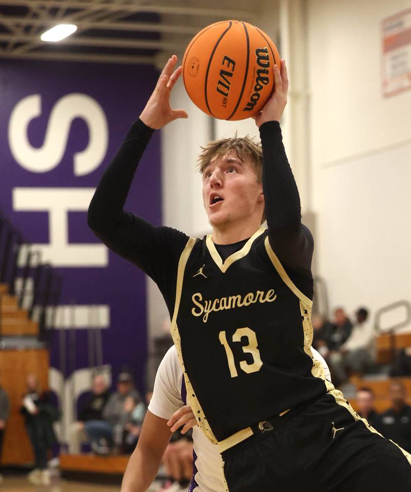 Sycamore's Xander Lewis gets a layup in front of Rochelle's Kasin Avila Friday, Dec. 5, 2025, during their game at Rochelle High School.
