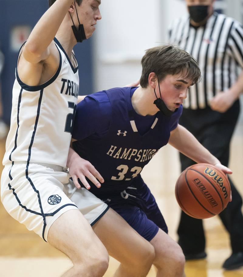 Hampshire's Sam Ptak pushes against Cary-Grove defender Zach Bauer during their game on Tuesday, January 25, 2022 at Cary-Grove High School in Cary.