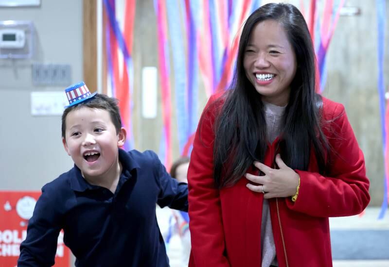 Linh Nguyen, Democratic candidate for DeKalb County Clerk, and her son Tommy Nguyen Wheeler, 6, smile as some election returns are announced Tuesday, Nov. 8, 2022, during an election night watch party at River Heights Golf Course in DeKalb.