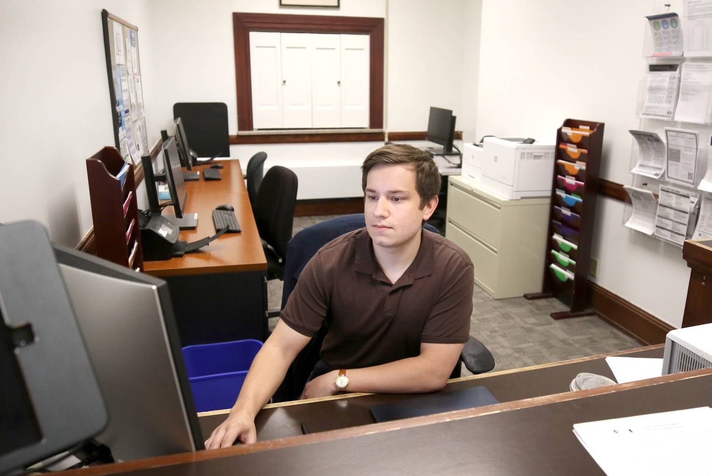 Nick DeMarco, 23, at the front desk of the Dekalb County Courthouse Self Help Legal Center, Tuesday, April 16, 2024. The center, which is on the first floor of the courthouse, provides procedural and legal information, forms, e-filing assistance and other resources to the public.