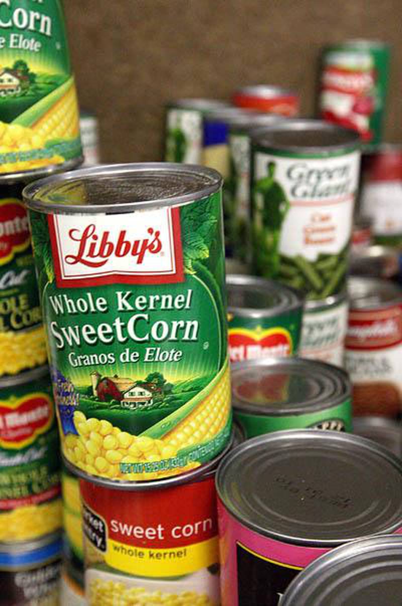 Stacks of sorted canned goods sit Friday afternoon before they are placed in Thanksgiving baskets by volunteers at The Salvation Army food pantry on Grove Street in DeKalb. Chronicle photo KATE WEBER