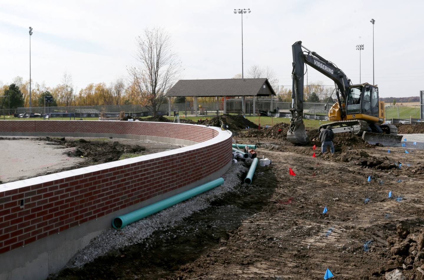Workers with Vissering Construction dig ground behind home plate at Schweickert Stadium on Thursday, Oct. 27, 2022 at the home of Illinois Valley Pistol Shrimp baseball at Veterans Park in Peru.