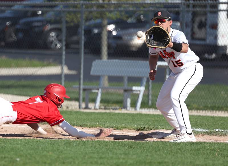 DeKalb’s Paul Kakoliris catches the ball on a late pickoff attempt as Naperville Central's Henry Paul dives back to first during their game Tuesday, April 30, 2024, at DeKalb High School.