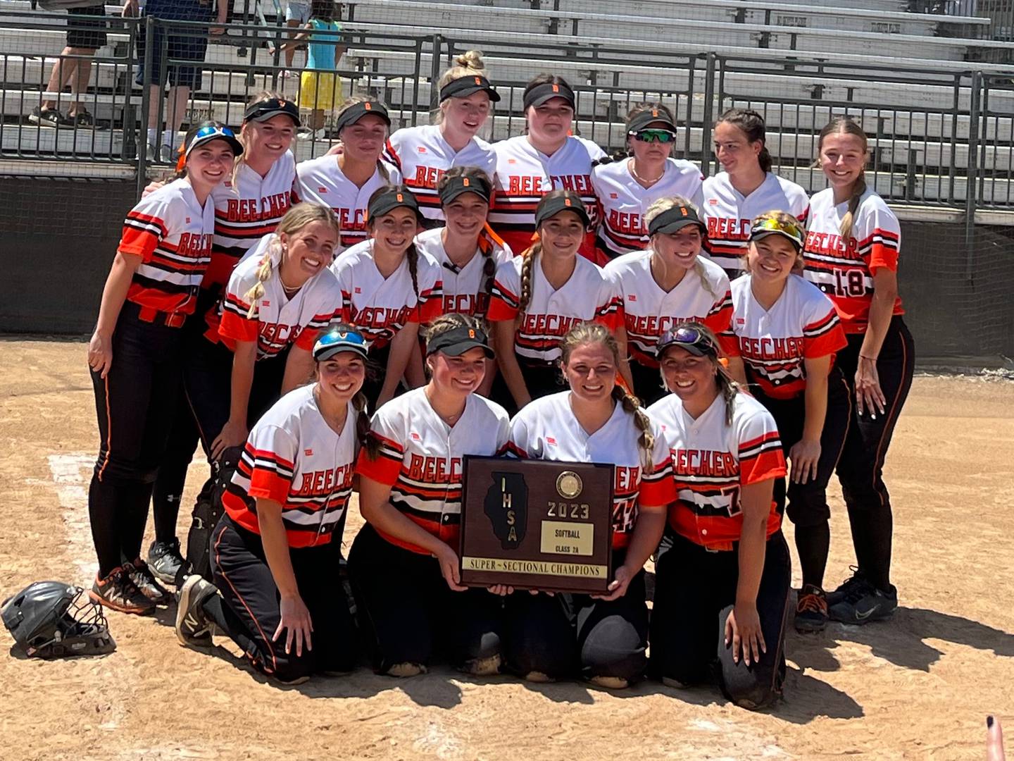 The Beecher softball team poses with the supersectional plaque after beating Montini 4-0 in the Class 2A Benedictine Supersectional on Monday in Lisle.