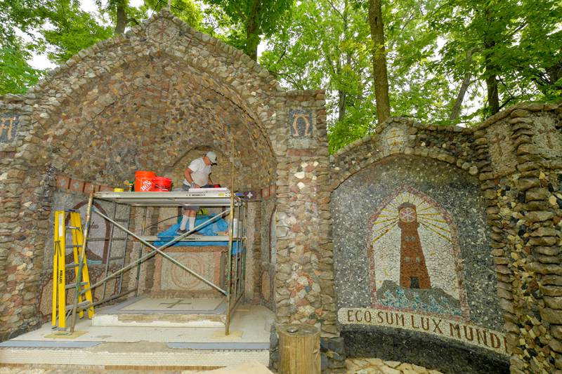 Volunteer Gary Olszanowski works on the restoration of the Geneva Grotto on Thursday, June 15, 2023.