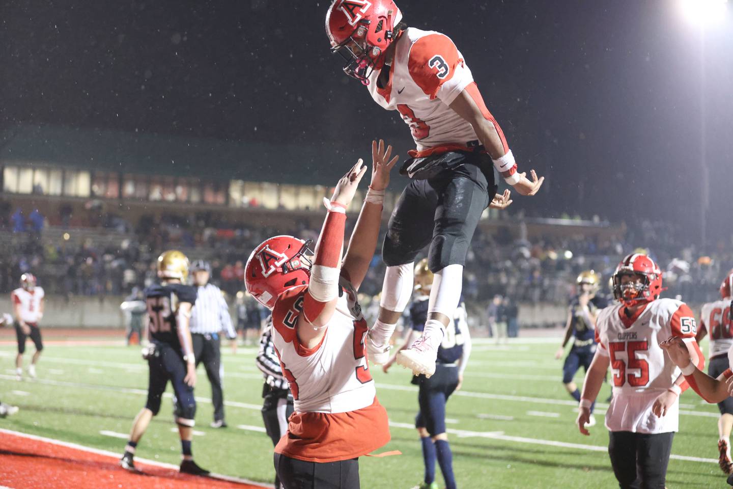 Amboy/LaMoille/Ohio's Cody Winn is thrown in the air by teammate Trevor Stenzel after scoring a touchdown during the 8-man I8FA championship game on Friday, Nov. 21, 2025 at April Zorn Memorial Stadium in Monmouth.