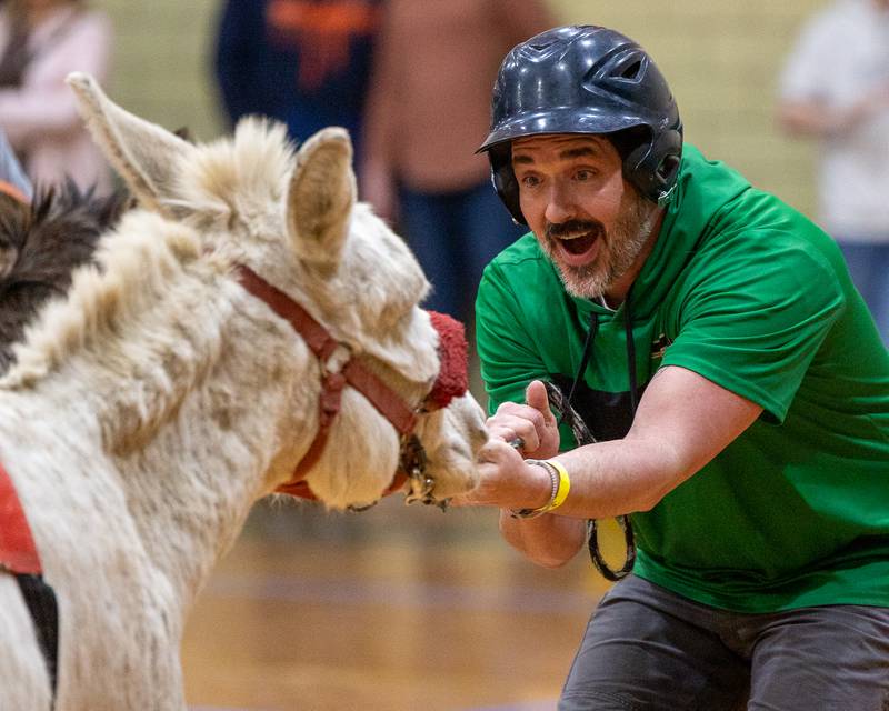 Seneca staff member Cory Yandell tugs on reigns of Donkey to get down court during game of Donkey Basketball on Saturday, Feb. 7, 2026 at Seneca High School West Campus in Seneca.