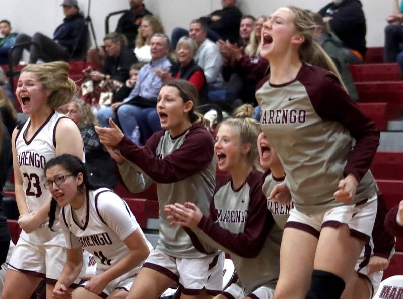 Marengo’s Indians get revved up during their game against Woodstock North in girls basketball at Marengo on Thursday.