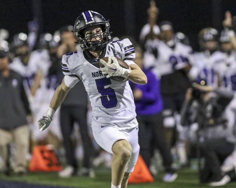 Downers Grove North's Maxwell Troha (5) runs in a touchdown during football game between Downers Grove North at Downers Grove South Friday, Sept 5, 2025  in Downers Grove.