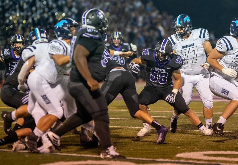 Downers Grove North's Ben Bielawski (58) spies the running back during a football game against Downers Grove South at Downers Grove North High School on Tuesday, Sep 9, 2022.