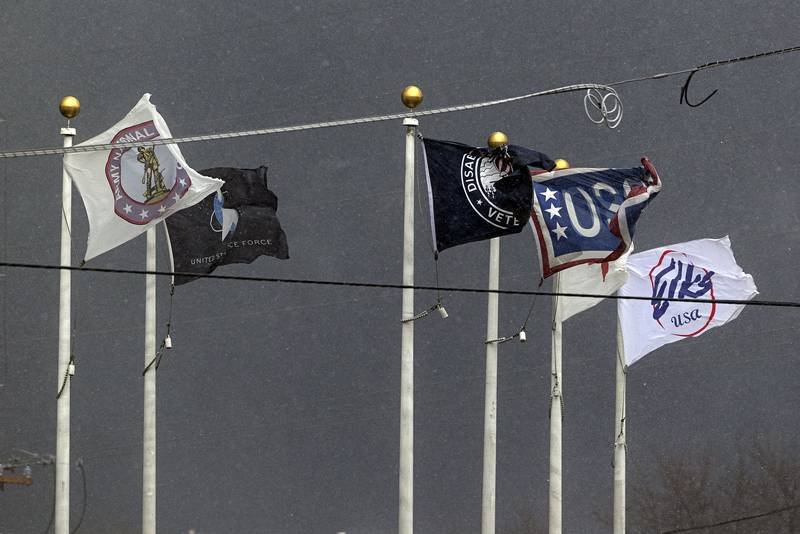 Flags whip and flutter in the wind as a strong storm carrying rain and hail slams Dixon Monday, April 3, 2023.