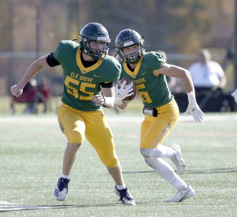 Elk Grove’s Joe Coveliers, 55, protects Logan Tosterud, 6, after an interception Saturday October 29, 2022 in Elk Grove Village.