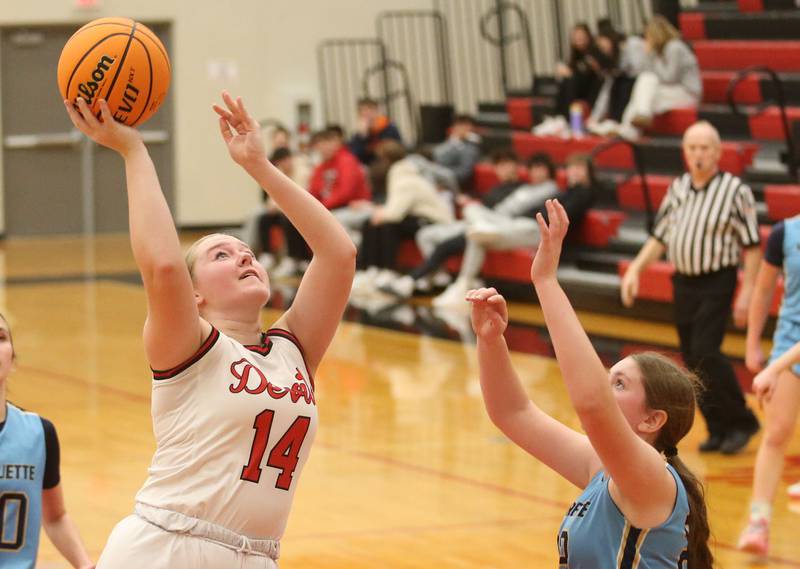 Hall's Jocelyn King lets go of a shot in the lane over Marquette's Kelsey Cuchra on Thursday, Feb. 13, 2025 at Hall High School.
