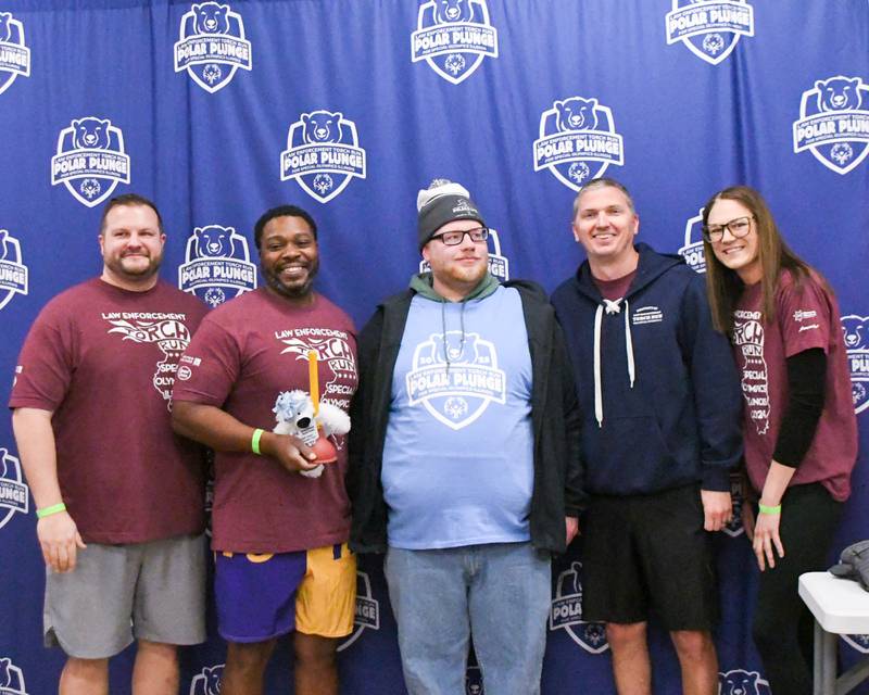 Ryan Celler (center) poses with members of the Sycamore Police Department, who were awarded the team to fundraise the most money, on Saturday, Feb. 15, 2025, during the 2nd annual Polar Plunge at Northern Illinois University's Huskie Stadium in DeKalb. Proceeds benefited the law enforcement torch run for Special Olympics.