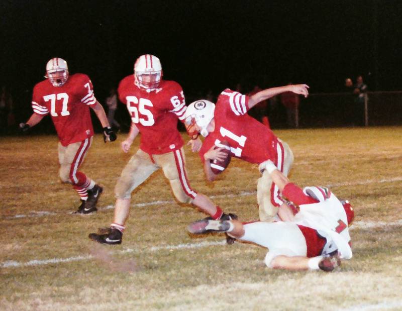 Ottawa quarterback Kyle Windy tries to fight his way out of a tackle from La Salle-Peru's Luke Yaklich (11) on Friday, Oct. 23, 1992 at King Field in Ottawa.