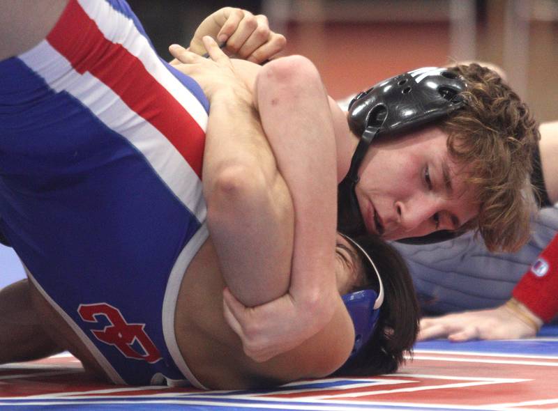 McHenry’s Pedro Jimenez, top, completes a win over Dundee-Crown’s Carlos Rodriguez at 145 pounds in varsity wrestling at Carpentersville Thursday night.