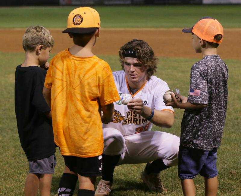 Pistol Shrimp's Tucker Bougie autographs a baseball for local kids after the Eastern Conference Championship game on Tuesday, Aug, 9 2022 at Schweickert Stadium in Veterans Park in Peru.