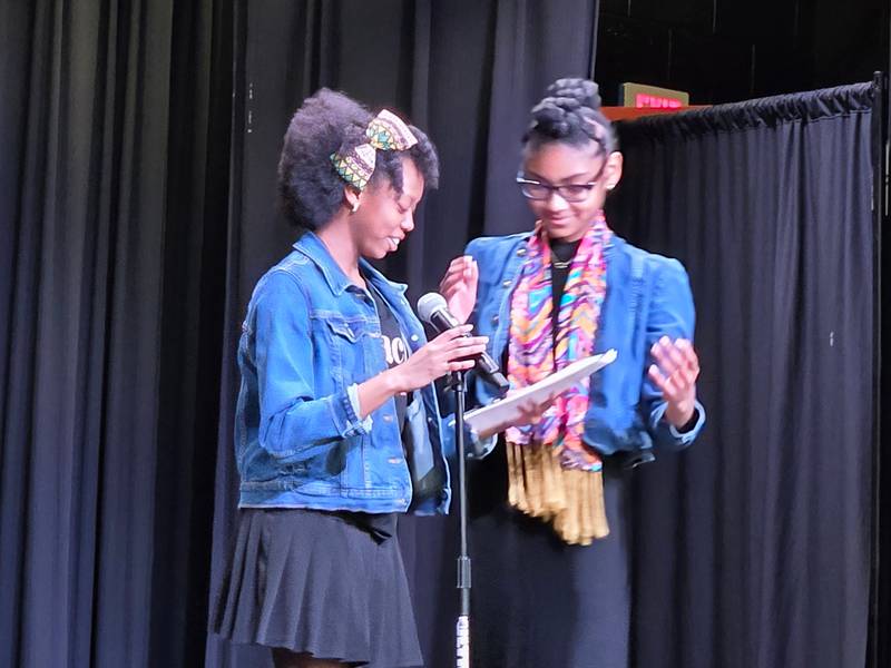 Jr. Emcees Caelyn McDaniel and Samiya McBean, eighth grade students, on stage introducing performers during the "Drop the Mic" event at Big Hollow School in Ingleside.