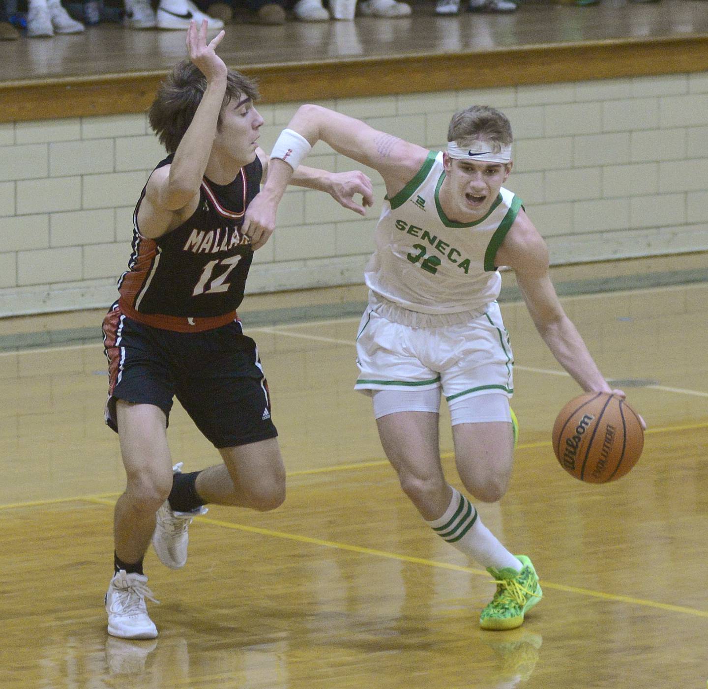 Seneca;s Paxton Giertz drives past the Mallard’sCarson Rowe in the 1st period Friday against Henry-Senachwine at the old west campus gym of Seneca.