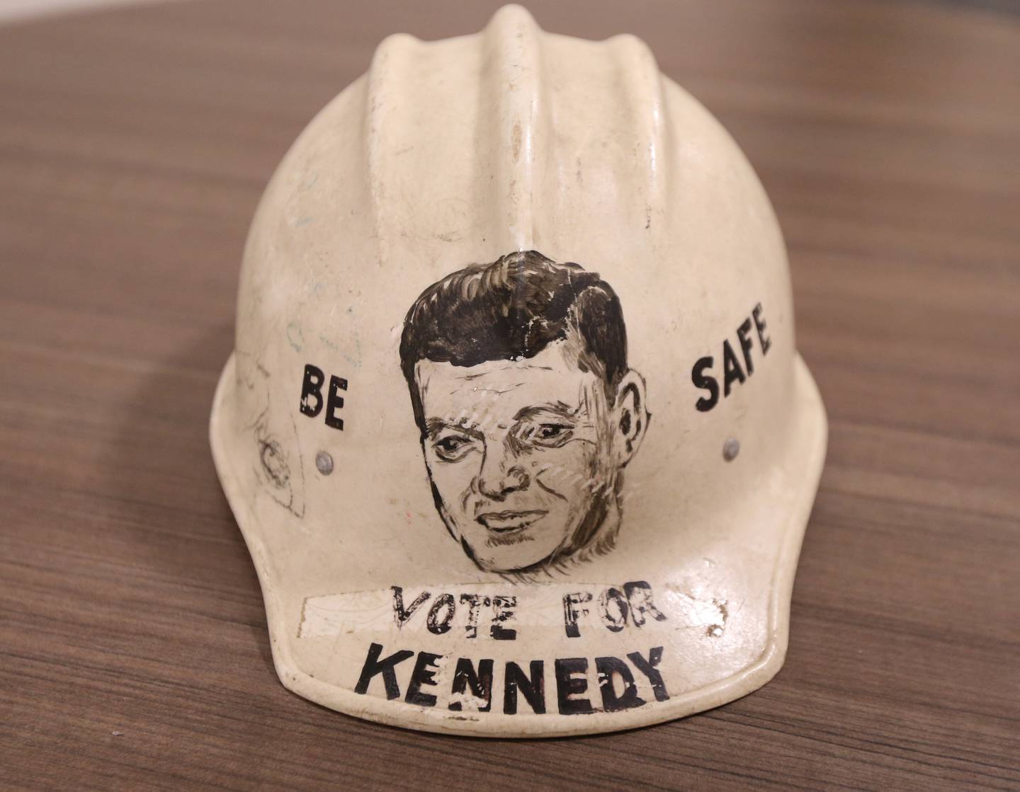 A "Be safe Vote for Kennedy" hard hat is on display Wednesday, Dec. 7, 2022 at L-P High School. Mr. Troy Woods, history instructor obtained the helmet from the Suarez family in 2012.  John Suarez Sr. painted the helmet and was passed down to his son John who gave it to Troy. Woods is donating it to the JFK Presidential Museum and Archives in Boston Mass.