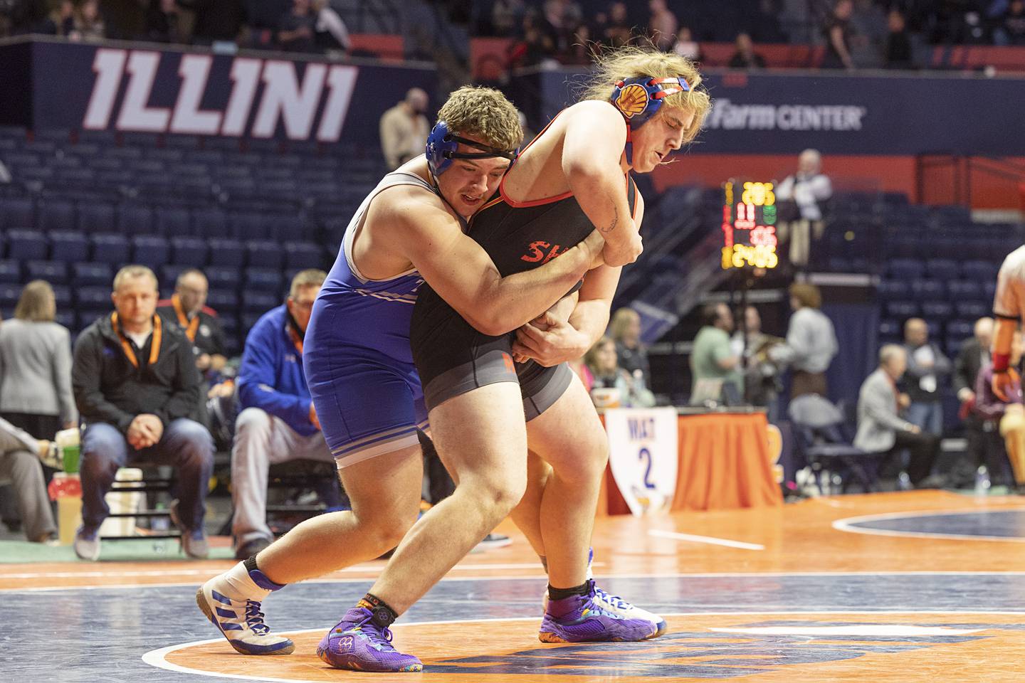 Princeton’s Cade Odell gets behind Roxana’s James Herring in the 285 pound 1A third place match Saturday, Feb. 17, 2024 at the IHSA state wrestling finals at the State Farm Center in Champaign.