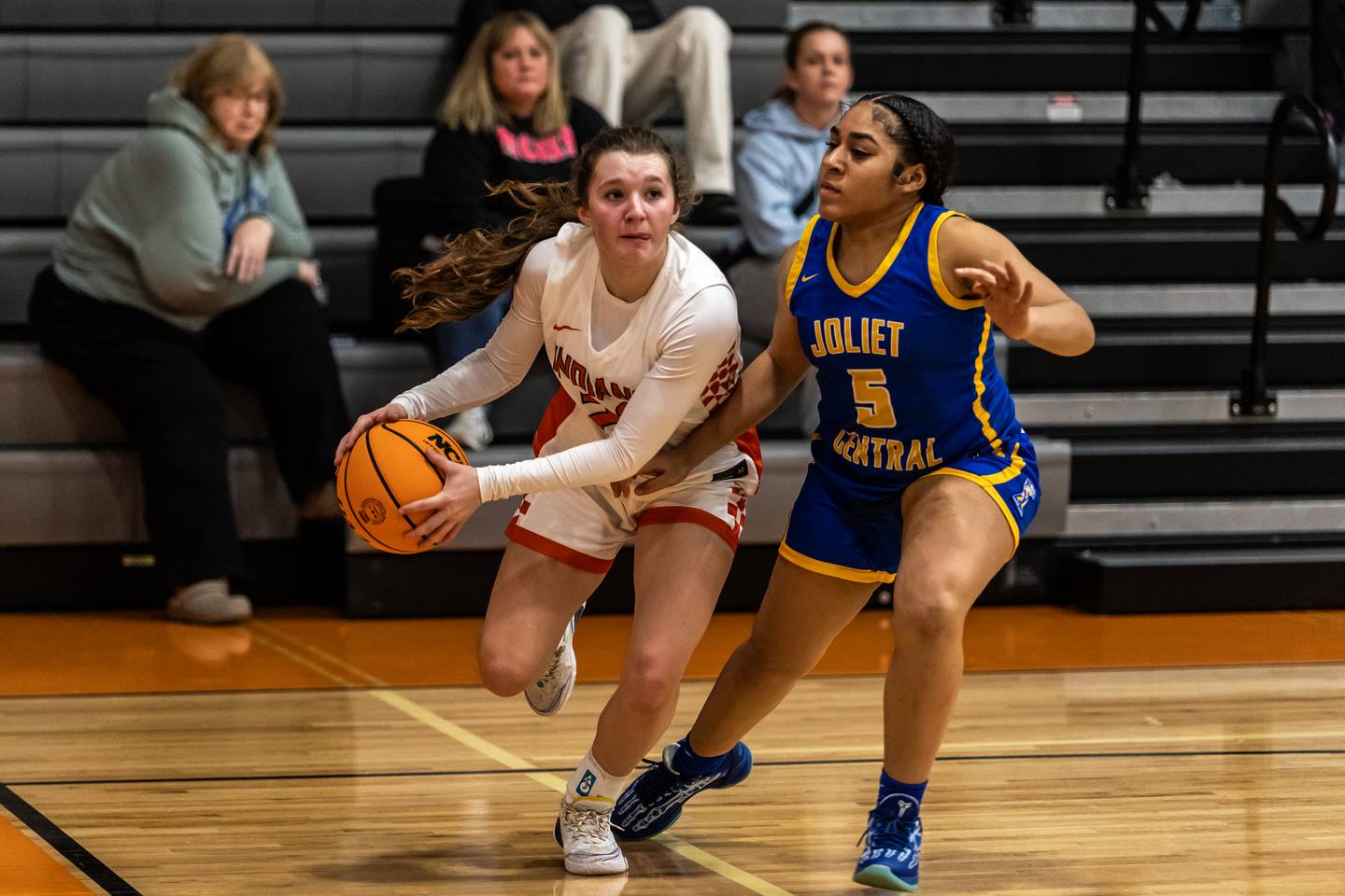 Minooka's Sadie Wedd drives to the basket as Joliet Central's Melani Tua-Link plays defense during a WJOL Girls Basketball Tournament game at Minooka on Nov. 19, 2025