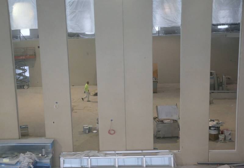 A worker walks between walls at the new YMCA building on Wednesday Jan. 24, 2024 in Ottawa.