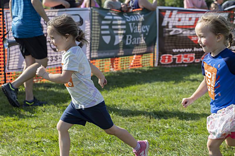 Twin sisters Layla (left) and Lilah Krone, 3, of Rock Falls head for the finish line Saturday, Sept. 30, 2023 at the Pumpkin Dash in Sterling.